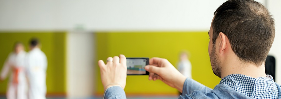 Man taking photo in judo class