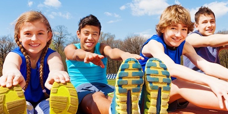 Kids stretching on grass