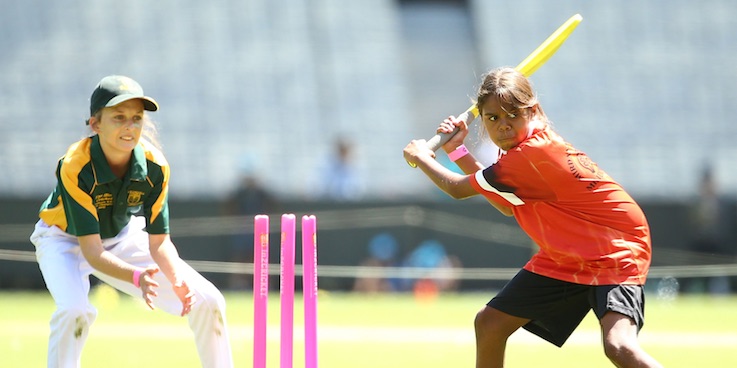 Girls playing cricket