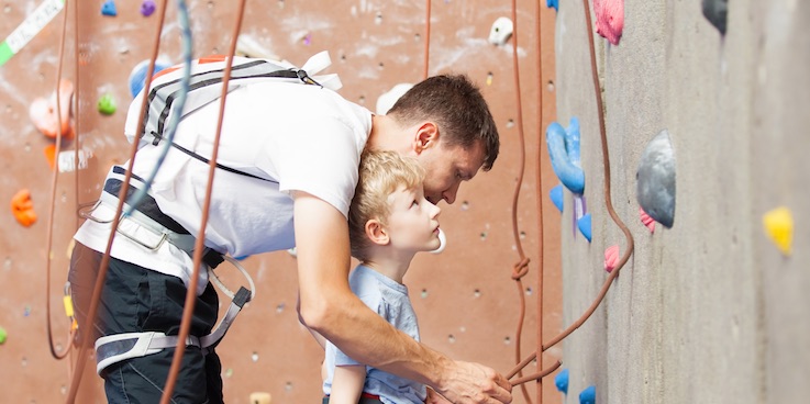 Young boy looking at climbing wall