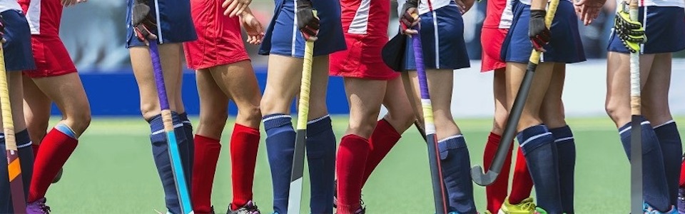 Girls playing hockey header