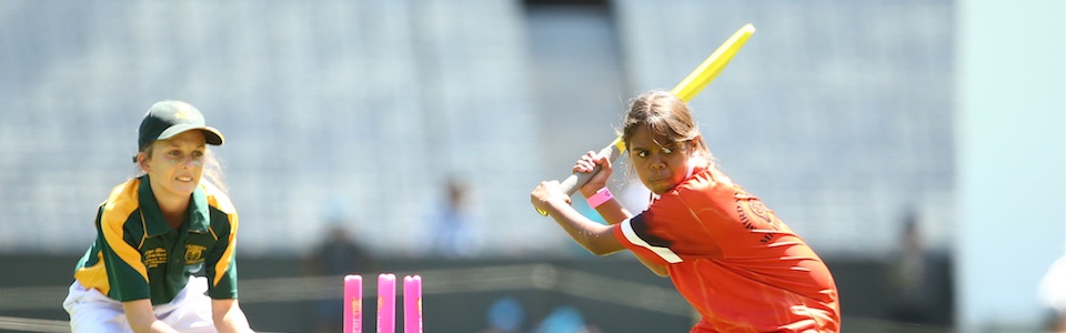 Girls playing cricket